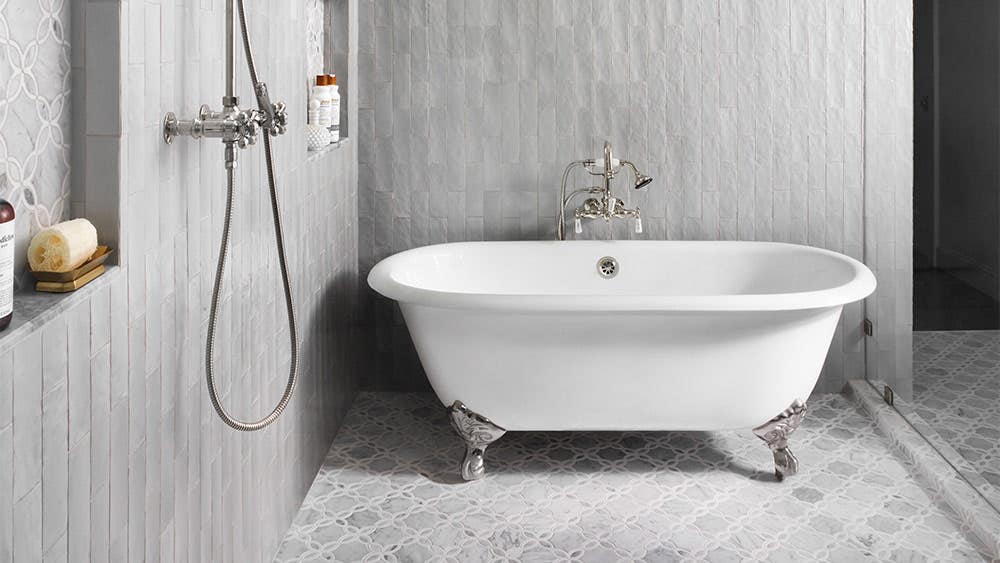 Double ended clawfoot tub in a gray wet room
